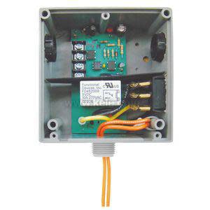 Open gray relay box with two circuit boards, plug-in relay and orange wires