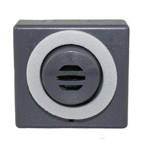 Square dark‑grey alarm module with circular vented center and light‑grey ring; labelled with 'UP' arrow.