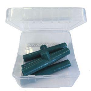 Transparent clamshell container open to reveal a handful of dark green plastic tube-like pieces inside.