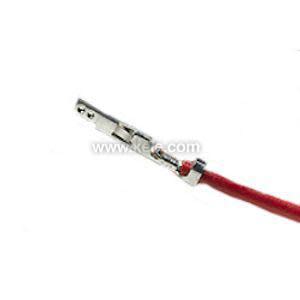 A close-up of a small silver electrical crimp connector affixed to the end of a red insulated wire, isolated on a white background.