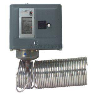 Rectangular metal housing with a round dial, three terminals and a long copper sensing tube coiled alongside.