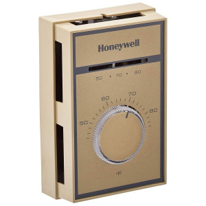 Beige rectangular thermostat with round temperature dial and printed temperature scale.