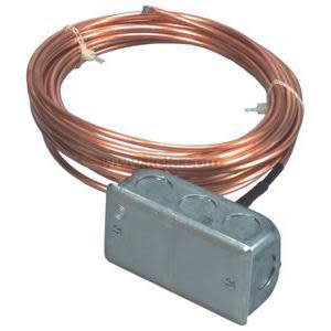 Coiled copper capillary tube attached to small metal electrical box for freeze sensing