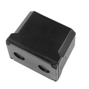A small black rectangular box with two round holes on its side and smooth slanted edges.
