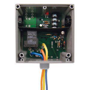 Square grey box showing internal circuit board with relay, terminals and colored wires