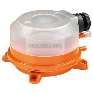 Small orange rectangular device with two brass barbed ports and an adjusting dial