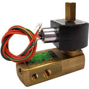 Close-up of an industrial valve with a long rectangular brass body with threaded holes and a black solenoid coil on top, from which a brass square rod protrudes; colored wires extend from the coil.