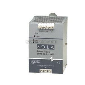 Photo of a rectangular grey metal industrial power supply module labeled 'Sola SDN 10‑24‑100P,' featuring terminal screw connectors on the top and bottom for wiring.