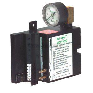 Black module with analog gauge, ports and adjustment screws.