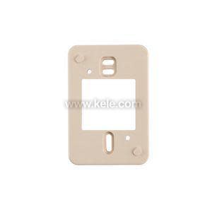 A flat beige mounting plate with a rectangular opening in the center and multiple small screw holes for attaching a thermostat to a wall