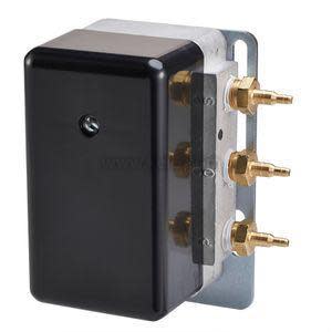 A small metal control unit encased in a glossy black cover, featuring several protruding brass tube connectors on the side.