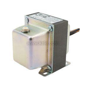 Compact control transformer with metal enclosure on one side and exposed laminated core with mounting flange.