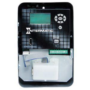 Timer control panel with screen, buttons and a small white module attached.