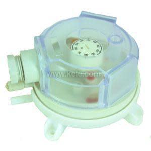 Small square grey box with clear plastic cover, circular scale and adjustment knob inside.