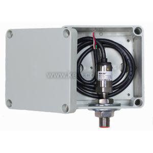 Gray box containing pressure gauge and fittings with attached wires.