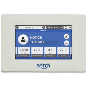 White rectangular monitor with blue touchscreen showing Room 121 occupied, numerical readings for pressure, temperature, humidity and air changes