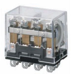 Transparent square relay housing showing internal contacts atop a black base with eight metal blades