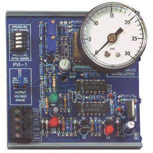 Green circuit board with a small analog gauge, adjustable knobs and terminal block