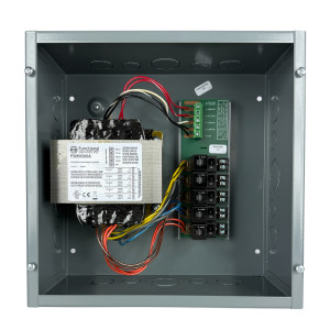 Open metal box showing large laminated transformer on left and terminal block circuit board on right with multicolored wires