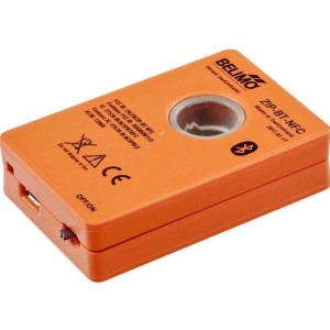 Small orange rectangular gadget with a round clear window in the centre and a sliding power switch on the side; marked with Belimo and Bluetooth symbols.
