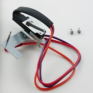 A small metal mounting assembly with a black top handle and attached red, purple, and orange electrical wires, accompanied by two screws on a white surface.