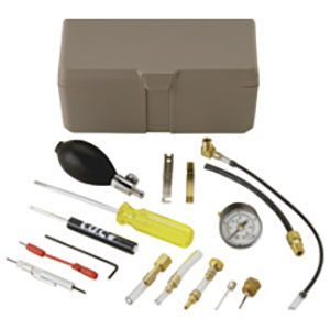 Kit containing brown case and assorted tools including screwdriver, pressure gauge, hand bulb pump and brass fittings.