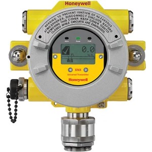 Round gas detection device with a small LCD screen, yellow casing, and several attached fittings.