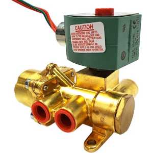 A gold-coloured poppet valve with two red-rimmed ports and a green solenoid housing on top featuring a caution sticker and red override button.