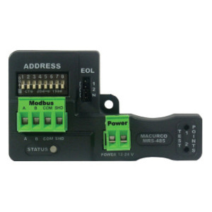 A small black circuit board labeled Macurco MRS-485 featuring tiny numbered switches at the top, two green terminal blocks labeled Modbus and Power, and connectors for testing.