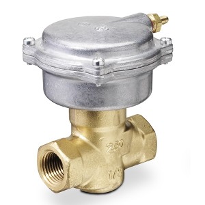Small brass valve with two openings and a silver actuator mounted on top
