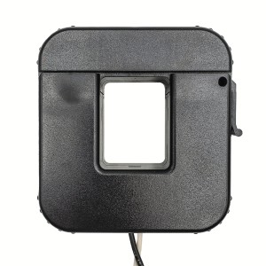 Large square black plastic current transformer with a rectangular window in the center and a white and black cable exiting from the bottom.