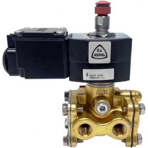 A brass industrial solenoid valve topped with a black rectangular coil housing and a red push‑button override on a stainless spindle.