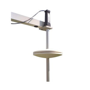 Cream disc radiation shield on vertical rod attached to an arm with a black sensor housing