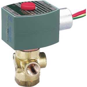 A small brass valve with multiple openings topped by a green rectangular electrical coil and a red button, with colorful wires coming out the side.
