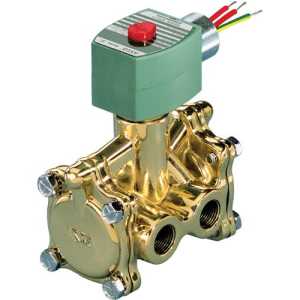 A shiny brass solenoid valve with multiple threaded ports, topped with a green actuator coil that has a red button and colored wires protruding.