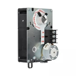 Rectangular actuator with exposed metal plate showing a circular dial indicator and a small motor gear at the bottom.